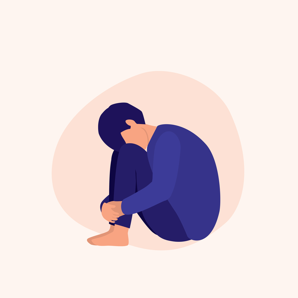 Illustration of troubled-looking person hugging knees