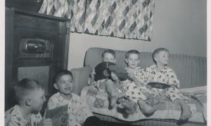 Children sit near the radio