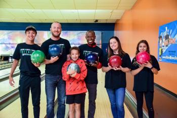 Bigs and Littles with bowling balls at bowling alley