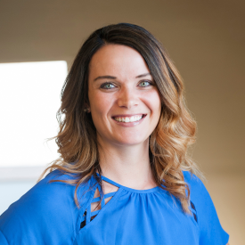 Female therapist with brunette hair and blue top on